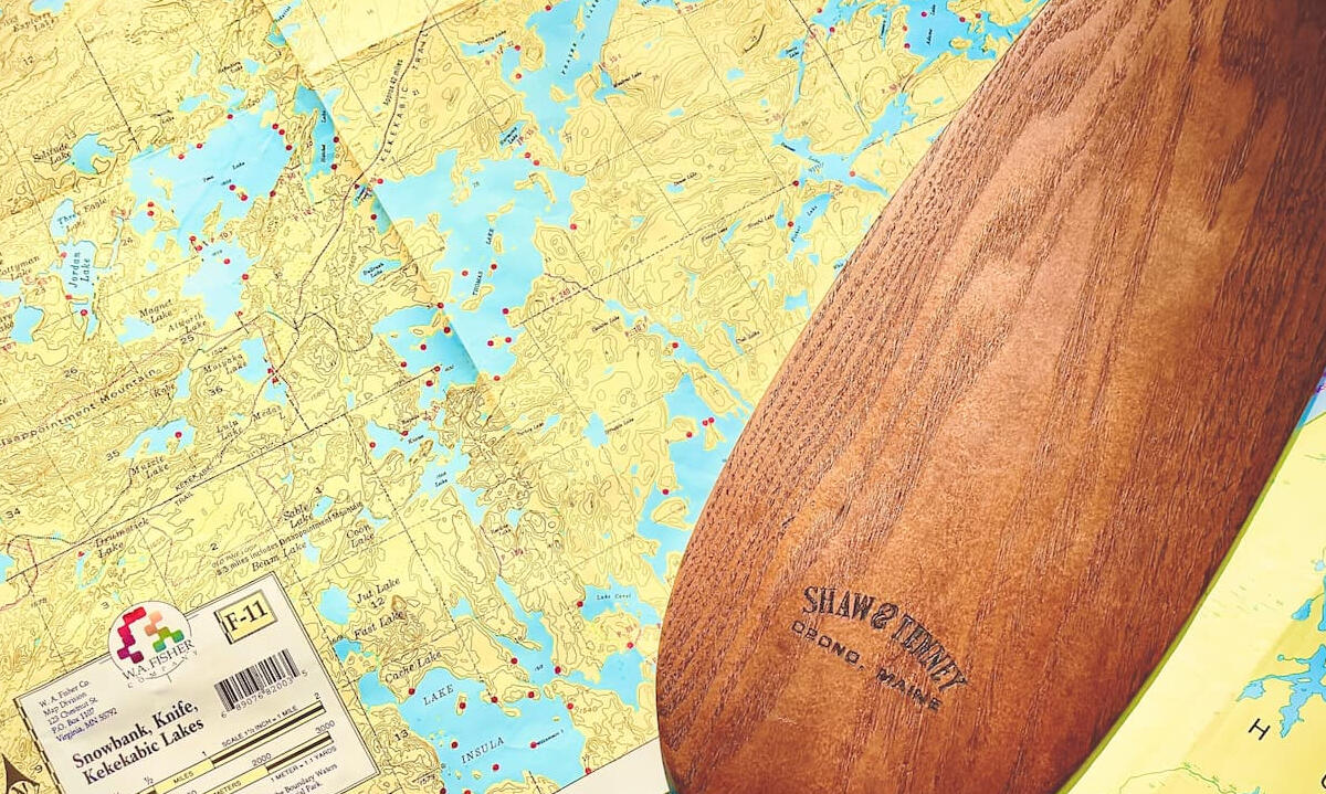 Wooden paddle on map of the Boundary Waters